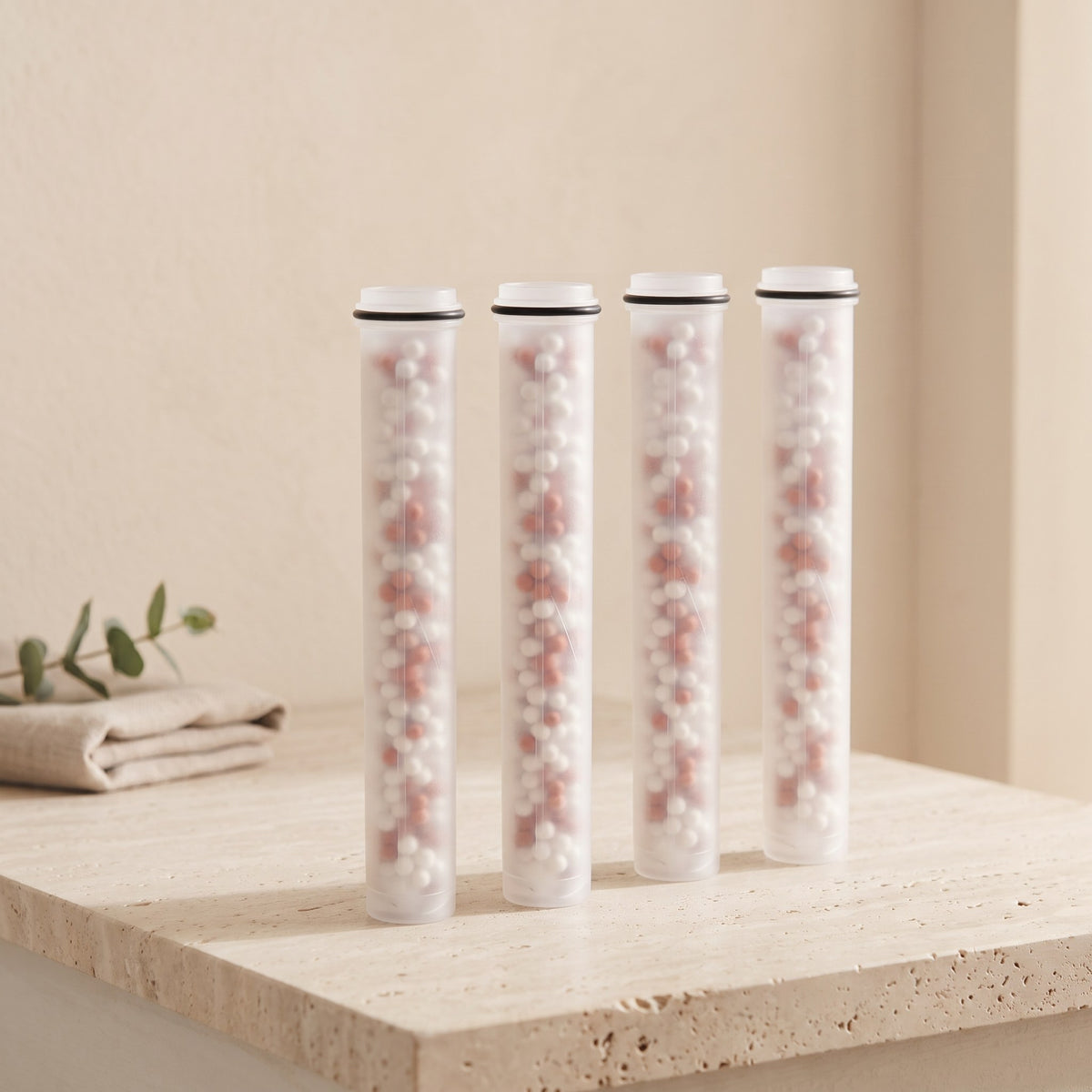 Illustration: four Driftrain refill cartridges in a row on a travertine bathroom ledge (AI-made image)