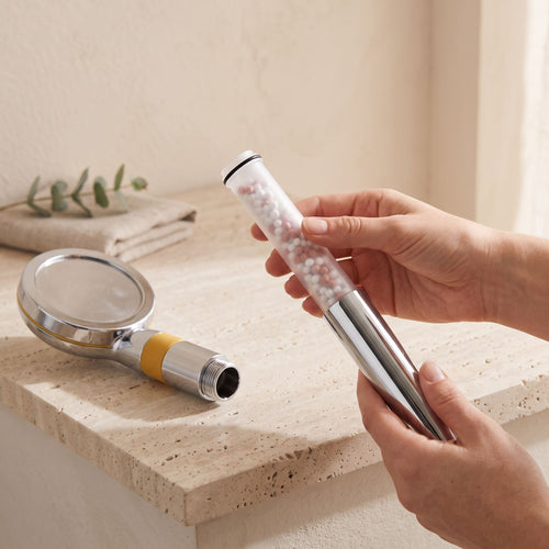 Illustration: a hand sliding a refill cartridge into the open Driftrain chrome handle (AI-made image)