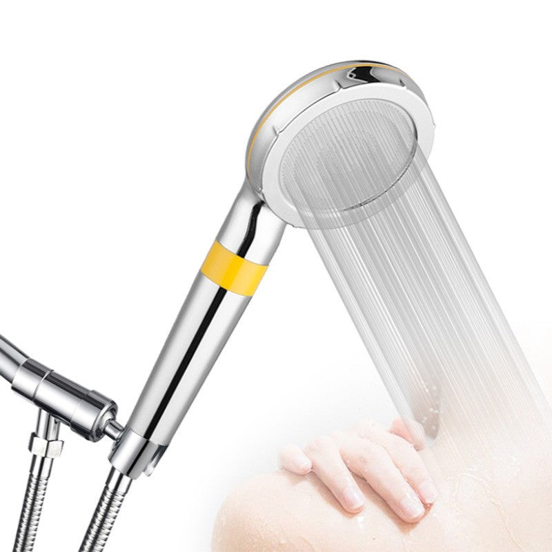 The handheld spraying while it sits in the holder bracket on a shower arm